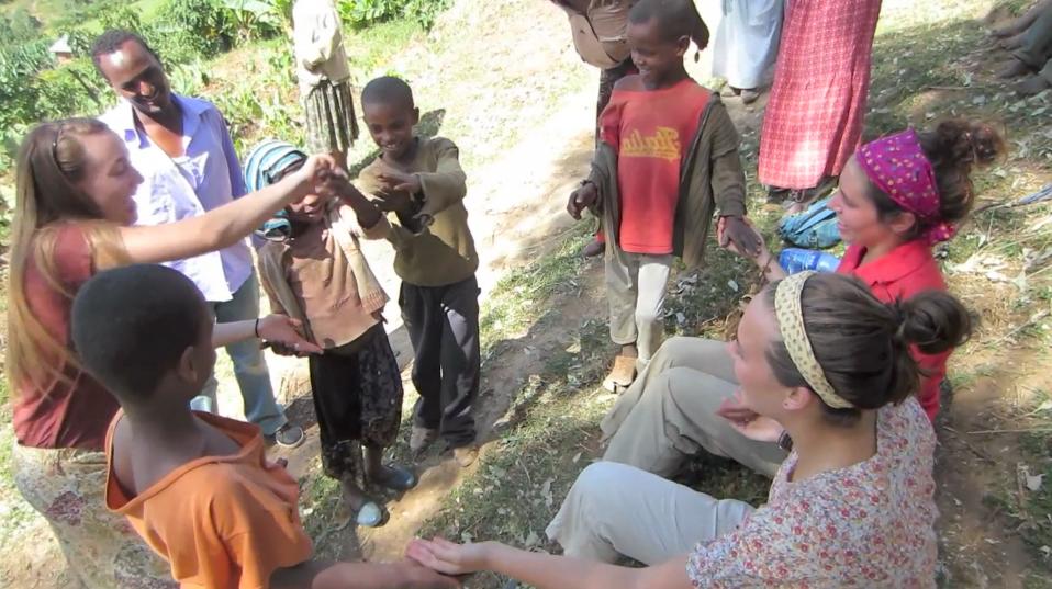 Students playing with children